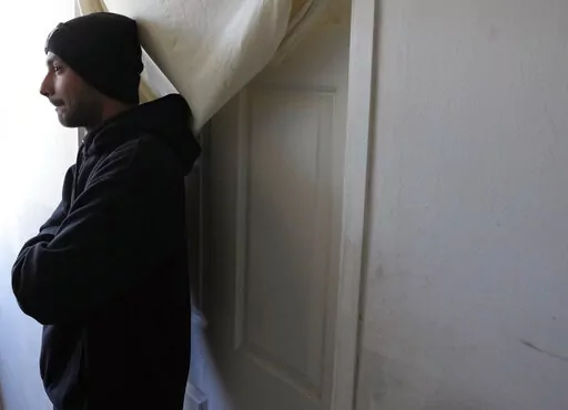 Hasib Qarizada a student from Afghanistan stands outside his room in the "Krnjaca" refugee centre near Belgrade, Serbia, Thursday, Feb. 24, 2022. While tens of thousands of refugees from Ukraine have found safety and help in Hungary, thousands of others weren't so lucky. Among them was Hasib Qarizada, a 25-year-old student from Afghanistan. He had been studying in Hungary for years butwas expelled last September even as his native country unraveled. (AP Photo/Darko Vojinovic)