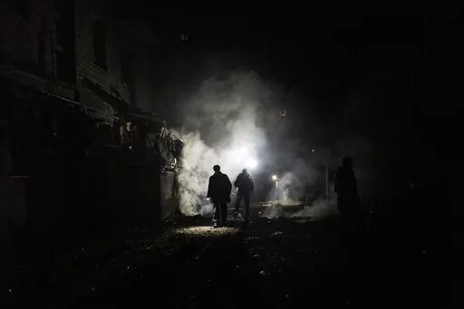 Resident walks amid debris after a Russian attack in Kherson, southern Ukraine, Nov. 24, 2022. In a deliberate, widespread campaign, Russian forces systematically targeted influential Ukrainians, nationally and locally, to neutralize resistance through detention, torture and executions, an Associated Press investigation has found. (AP Photo/Bernat Armangue, File)