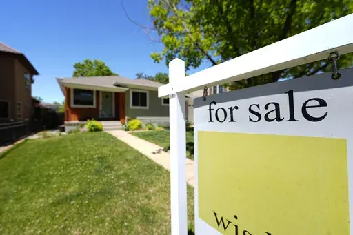 A for sale sign stands outside a single-family residence on the market Wednesday, May 22, 2024, in southeast Denver. (AP Photo/David Zalubowski, File)