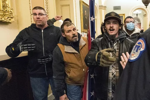 Michael Sparks, left, and Kevin Seefried, second from left, as they and other insurrectionists loyal to President Donald Trump are confronted by U.S. Capitol Police officers outside the Senate Chamber inside the Capitol in Washington, Jan. 6, 2021. Sparks, the first rioter to enter the Capitol building during the Jan. 6, 2021, attack has been convicted of charges that he interfered with police and obstructed Congress from certifying President Joe Biden's 2020 electoral victory.(AP Photo/Manuel B
