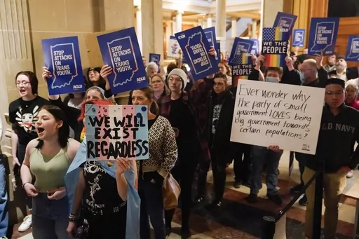 Protesters stand outside of the Senate chamber at the Indiana Statehouse on Feb. 22, 2023, in Indianapolis. A federal judge is scheduled Wednesday, June 14, to hear arguments in a lawsuit seeking to block an Indiana law banning doctors from providing puberty blockers, hormones and gender-affirming surgeries to minors. (AP Photo/Darron Cummings, File)