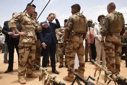 French President Emmanuel Macron, center left, visits soldiers of Operation Barkhane, France's largest overseas military operation, in Gao, Northern Mali on May 19, 2017. High-stakes legislative elections this Sunday will almost certainly impact the French leader's sway in the fields of defense and foreign affairs, quite possibly diminishing his role as an energetic and influential figure in European and world affairs and as one of Ukraine's primary backers in the war against Russia, say retired