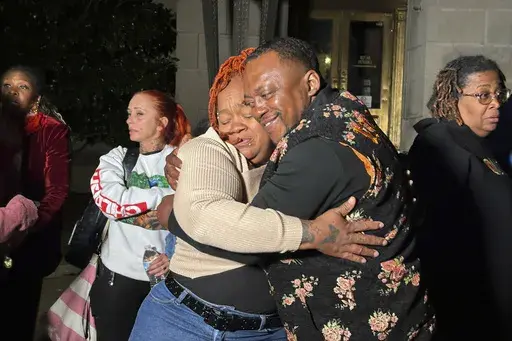 Breonna Taylor's mother, Tamika Palmer, center left, hugs a friend in Louisville, Ky., Friday, Nov. 1, 2024, after a former Kentucky police officer was convicted in federal court for using excessive force when he fired his gun during the deadly raid that left Taylor dead in 2020. (AP Photo/Dylan Lovan)