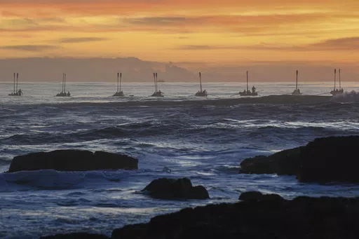 Surf boats perform during the Anzac Day dawn service at Elephant Rock in Currumbin on the Gold Coast, Australia, Thursday April 25, 2024. (Jono Searle/AAP Image/via AP)