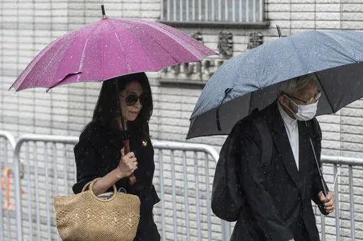 Jimmy Lai's wife Teresa Lai, left, and retired Chinese cardinal Joseph Zen Ze-Kiun arrive at West Kowloon Magistrates' Courts to attend Hong Kong activist publisher Lai's national security trial in Hong Kong, Wednesday, Nov. 20, 2024. (AP Photo/Chan Long Hei)