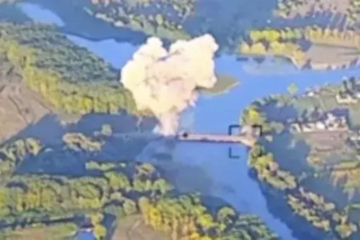 In this footage released by the Ukrainian armed forces on Sunday, Aug. 18, 2024, smoke billows in . what is said to show the destruction of a key bridge in Russia's Kursk region. Ukraine has destroyed a key bridge in Russia's Kursk region and struck a second one nearby, less than two weeks into its stunning cross-border incursion, disrupting Russian supply routes and possibly signaling that its troops are planning to dig in. (Ukrainian Armed Force via AP)