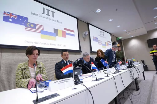 Digna van Boetzelaer, the Netherlands, Andy Kraag, the Netherlands, David McLean, Australia, Asha Hoe Soo Lian, Malaysia, Eric van der Sypt, Belgium, and Oleksandr Bannyk, Ukraine, take their seats for the Joint Investigation Team (JIT) news conference in The Hague, Netherlands, Wednesday, Feb. 8, 2023, on the results of the ongoing investigation into other parties involved in the downing of flight MH17 on 17 July 2014. The JIT investigated the crew of the Buk-TELAR, a Russian made rocket launch