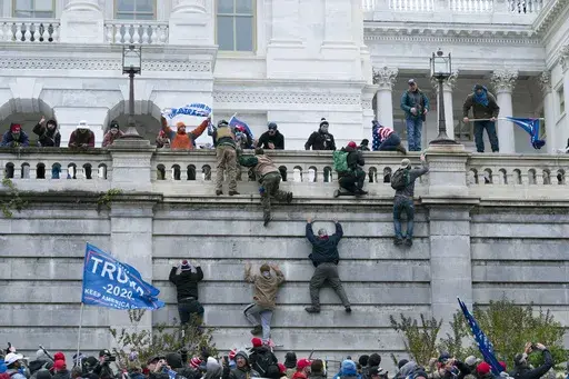 Supporters of President Donald Trump climb the west wall of the the U.S. Capitol in Washington, Jan. 6, 2021. (AP Photo/Jose Luis Magana, File)