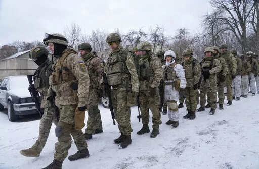 Members of Ukraine's Territorial Defense Forces, volunteer military units of the Armed Forces, train in a city park in Kyiv, Ukraine, Saturday, Jan. 22, 2022. Dozens of civilians have been joining Ukraine's army reserves in recent weeks amid fears about Russian invasion. (AP Photo/Efrem Lukatsky)