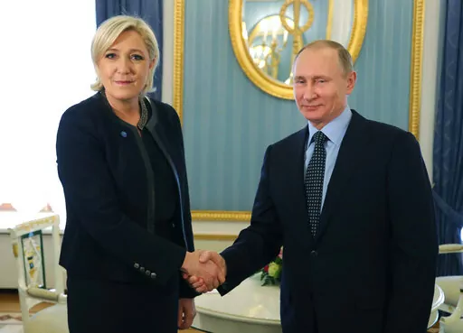Russian President Vladimir Putin, right, shakes hands with French far-right presidential candidate Marine Le Pen, in the Kremlin in Moscow, Russia, Friday, March 24, 2017. France is thousands of miles from Ukraine, but what happens in French voting stations this month could have repercussions in Ukrainian battlefields. Nationalist candidate Marine Le Pen wants to halt arms supplies to Ukraine, improve Western ties with Russia and weaken the EU and NATO, which would undermine long-held Western al