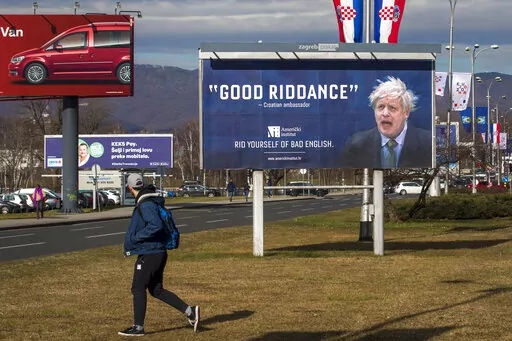 An advertising billboard for an English language school depicts Britain's prime minister Boris Johnson, in Zagreb, Croatia, Feb. 6, 2020. Outgoing U.K. Prime Minister Boris Johnson has been the bane of Brussels for many years, from his days stoking anti-European Union sentiment with exaggerated newspaper stories to his populist campaign leading Britain out of the bloc and reneging on the post-Brexit trade deal he himself signed. (AP Photo/Darko Bandic, file)