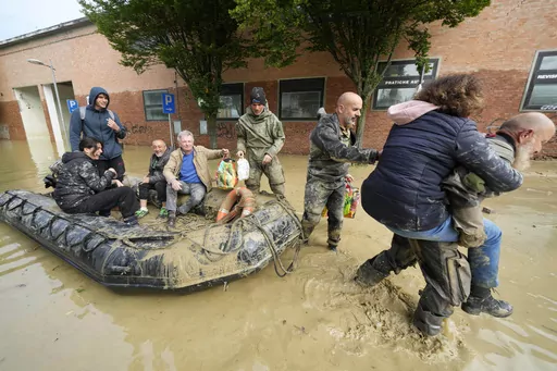 People are rescued in Faenza, Italy, on May 18, 2023. A rare, triple-whammy of cyclones drove the deadly flooding that devastated much of northern Italy this month, but scientists said Wednesday May 31, 2023 that climate change doesn't seem to be to blame for the intense rainfall. (AP Photo/Luca Bruno, File)