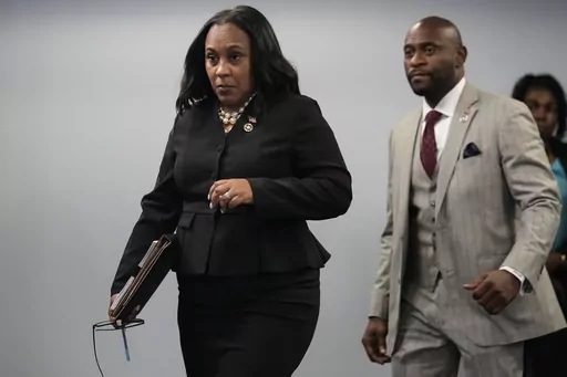 Fulton County District Attorney Fani Willis, followed by special prosecutor Nathan Wade, right, arrives for a news conference at the Fulton County Government Center, Monday, Aug. 14, 2023, in Atlanta. Willis acknowledged in a court filing on Friday, Feb. 2, 2024, having a “personal relationship” with Wade, a special prosecutor she hired for the Georgia election interference case against former President Donald Trump, but argued there are no grounds to dismiss the case or to remove her from t
