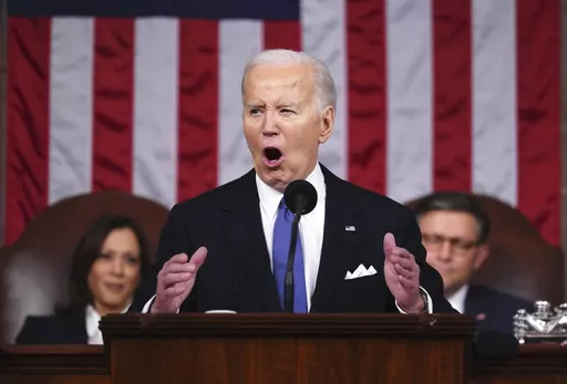 President Joe Biden delivers the State of the Union address to a joint session of Congress at the Capitol, March 7, 2024, in Washington. Seated at left is Vice President Kamala Harris and at right is House Speaker Mike Johnson, R-La. Biden made abortion and reproductive rights a central theme of his State of the Union speech, but he never mentioned the word "abortion." Pushback over how he addressed the issue is the latest example of Biden's fraught history with the topic. (Shawn Thew/Pool via A