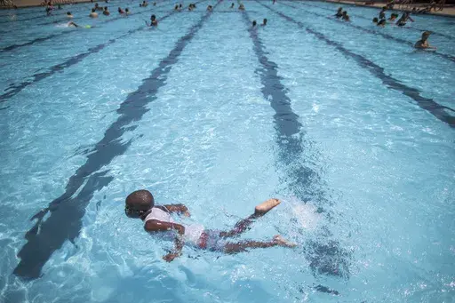 Children cool off at the Hamilton Fish pool, July 18, 2017, in the Lower East Side neighborhood of Manhattan. In most cases, there’s no need to wait at least 30 minutes after eating to go for a swim, doctors say. (AP Photo/Mary Altaffer, File)