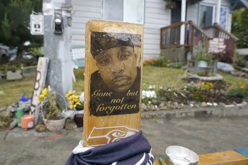 A sign is displayed on May 27, 2021, at a memorial in Tacoma, Wash., where Manuel "Manny" Ellis died March 3, 2020, after he was restrained by police officers. Opening statements are expected to begin as early as Tuesday, Oct. 3, 2023, in the trial of the three officers charged with Ellis' death. (AP Photo/Ted S. Warren, File)