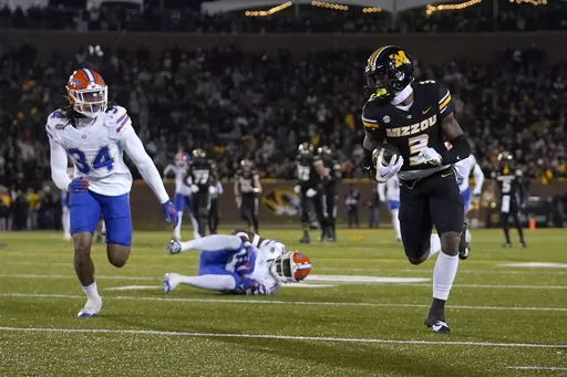 Missouri wide receiver Luther Burden III (3) runs with the ball after catching a pass as Florida linebacker Mannie Nunnery (34) defends during the second half of an NCAA college football game Saturday, Nov. 18, 2023, in Columbia, Mo. Missouri won 33-31. (AP Photo/Jeff Roberson)