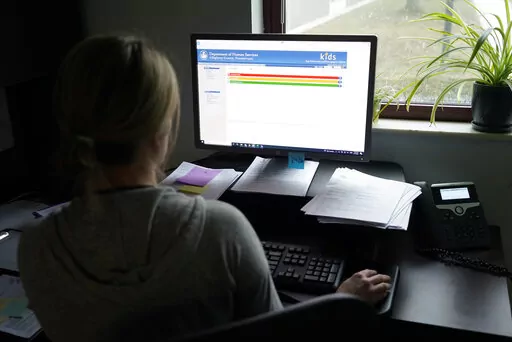 Case work supervisor Jessie Schemm looks over the first screen of software used by workers who field calls at an intake call screening center for the Allegheny County Children and Youth Services, in Penn Hills, Pa. The Justice Department has been scrutinizing a controversial artificial intelligence tool used by a Pittsburgh-area child protective services agency following concerns that it could result in discrimination against families with disabilities, The Associated Press has learned. (AP Phot