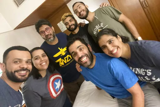This photo from March 2020 shows participants, from left,  Zubin Gheesta, Parinaz Navder, trip leader Arzan Sam Wadia, Sheherazad Pavri, Zruvan Chothia, Kayras Irani (bright blue shirt in the front), Mahfrin Santoke, in a group trip to Mumbai, India organized by Zoroastrian Return to Roots. The aim of the trip to help young Zoroastrians from other parts of the world learn more about the culture and history of their ancient faith.  (Zoroastrian Return to Roots via AP)