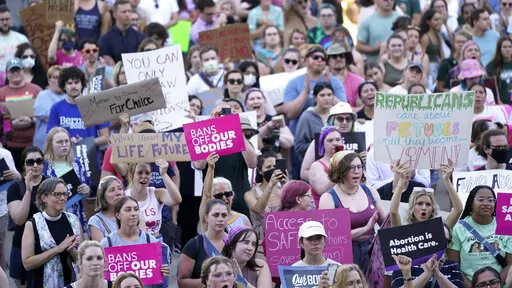 In this Friday, June 24, 2022, file photo, abortion rights protesters cheer at a rally following the United States Supreme Court's decision to overturn Roe v. Wade, federally protected right to abortion, outside the state capitol in Lansing, Mich. The Michigan Court of Appeals ruled Monday, Aug. 1, 2022, that county prosecutors can enforce the state's 91-year-old abortion ban, paving the way for abortion to become illegal in parts of the state. (AP Photo/Paul Sancya, File)