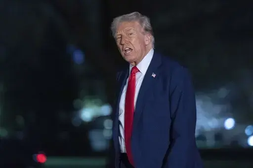 President Donald Trump talks to reporters as he walks on the South Lawn of the White House, in Washington, Sunday, March 30, 2025. (AP Photo/Jose Luis Magana)