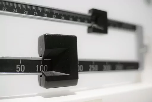 FILE- A closeup of a beam scale is seen in New York on April 3, 2018. Tirzepatide, a drug from Eli Lilly and Co. approved to treat type 2 diabetes under the brand name Mounjaro, helped people with the disease who were overweight or had obesity lose up to 16% of their body weight, or more than 34 pounds, over nearly 17 months, the company said on Thursday, April 27, 2023. (AP Photo/Patrick Sison, File)