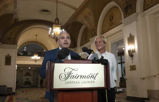 Fairmont Chateau Laurier General Manager Genevieve Dumas looks on as Ottawa Police Services Detective Akiva Gellar speaks about the stolen Yousuf Karsh portrait of Winston Churchill, during a news conference in the hotel in Ottawa, Canada, Wednesday, Sept. 11, 2024. (Adrian Wyld/The Canadian Press via AP)