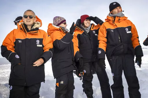 New Zealand Prime Minister Jacinda Ardern, second right, with her partner Clarke Gayford, right, are explained the sites by Antarctica New Zealand chief executive Sarah Williamson shortly after stepping off the plane in Antarctica, Wednesday, Oct. 26, 2022. Delegations from Russia and Ukraine are among those meeting in Australia this week to decide the future of Antarctica's pristine waters. (Mike Scott/NZ Herald/Pool via AP)