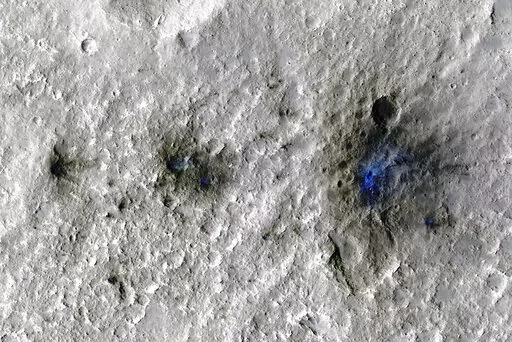 This undated photo released by NASA shows craters that were formed by a Sept. 5, 2021, meteoroid impact on Mars, the first to be detected by NASA’s InSight. Taken by NASA’s Mars Reconnaissance Orbiter, this enhanced-color image highlights the dust and soil disturbed by the impact in blue in order to make details more visible to the human eye. NASA lander on Mars has captured the vibrations and sounds of four meteorites striking the planet's surface. Scientists reported Monday, Sept. 19, 2022