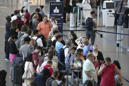 Passengers wait in line for assistance at the Delta Terminal, July 19, 2024, at Logan International Airport in Boston. Delta CEO Ed Bastian says the airline is facing $500 million in costs for the global technology breakdown that happened earlier this month. (AP Photo/Michael Dwyer, File)