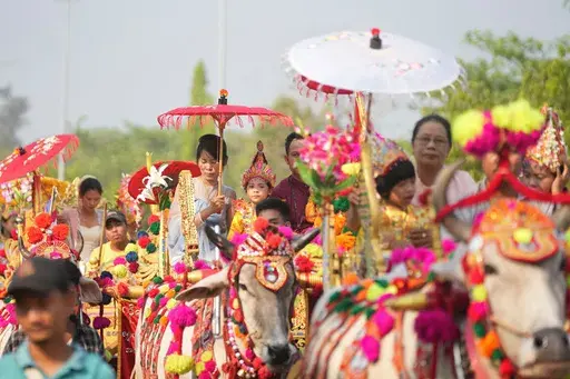 Children who are to become Buddhist nuns ride on decorated cow carts during a processional parade as part of a celebration of a novitiation or “Shinbyu,” ceremony, Saturday, March 15, 2025, at Hlegu township, outside of Yangon, Myanmar. (AP Photo/Thein Zaw)