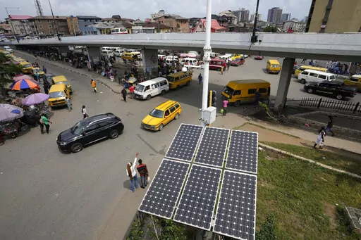 Solar panels sit near a street in the Obalende neighborhood of Lagos, Nigeria, Saturday, Aug. 20, 2022. Access to more and cleaner energy while continuing to grow economically will be a top priority for African nations in the upcoming United Nations climate conference in November, top officials and climate experts on the continent said. (AP Photo/Sunday Alamba)