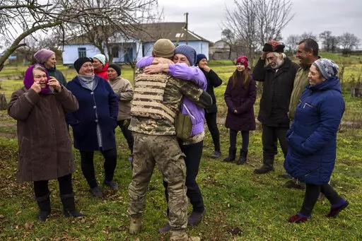 In the village of Vavylove, a Ukrainian serviceman embraces his mother for the first time since Russian troops withdraw from the Kherson region, southern Ukraine, Sunday, Nov. 13, 2022. Families were torn apart when Russia invaded in February, as some fled and others hunkered down. Now many are seeing one another for the first time in months, after Moscow's latest retreat amid a Ukrainian counteroffensive that has retaken a pocket of territory wedged between the regional capitals of Kherson and 