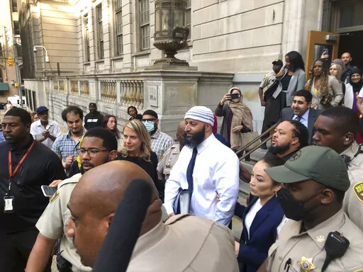 Adnan Syed, center, leaves the Elijah E. Cummings Courthouse, Monday, Sept. 19, 2022, in Baltimore. A judge has ordered the release of Syed after overturning his conviction for a 1999 murder that was chronicled in the hit podcast “Serial.” (AP Photo/Brian Witte)