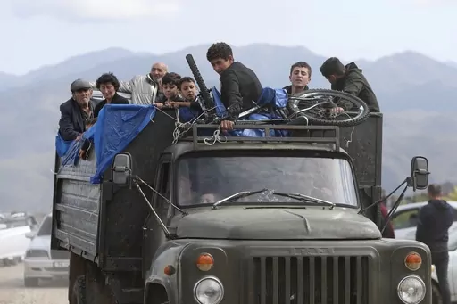 Ethnic Armenians from Nagorno-Karabakh travel on a truck on their way to Kornidzor, Armenia, on Sept. 26, 2023. Israel has quietly helped fuel Azerbaijan’s campaign to recapture Nagorno-Karabakh, officials and experts say, supplying powerful weapons to Azerbaijan ahead of its lightening offensive last month that brought the Armenian enclave in its territory back under its control.(Stepan Poghosyan, Photolure photo via AP, File)