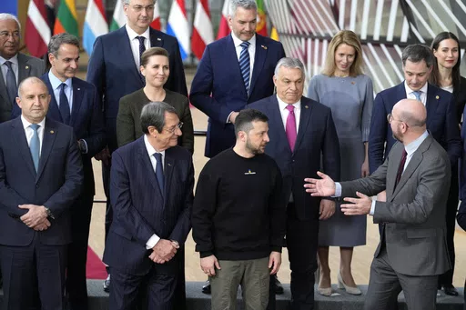 European Council President Charles Michel, front right, speaks with Ukraine's President Volodymyr Zelenskyy, front second right, and Hungary's Prime Minister Viktor Orban, second row center, as they pose with other European Union leaders for a group photo at an EU summit in Brussels on Thursday, Feb. 9, 2023. The European Union decided Thursday, Dec. 14, 2023 to open accession negotiations with Ukraine, a stunning reversal for a country at war that had struggled to find the necessary backing for