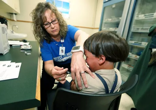 A registered nurse and immunization outreach coordinator with the Knox County Health Department, administers a vaccination to a kid at the facility in Mount Vernon, Ohio, Friday May 17, 2019. In a report issued Wednesday, Nov. 23, 2022, the World Health Organization and the U.S. Centers for Disease Control and Prevention say measles immunization has dropped significantly since the coronavirus pandemic began, resulting in a record high of nearly 40 million children missing a vaccine dose last yea