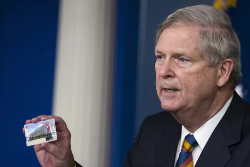 Agriculture Secretary Tom Vilsack holds up a Supplemental Nutrition Assistance Program Electronic Benefits Transfer (SNAP EBT) card during a news conference at the White House, Wednesday, May 5, 2021, in Washington. Nearly 21 million children in the U.S. and its territories are expected to receive food benefits this summer through a newly permanent federal program, the United States Department of Agriculture announced Wednesday, Jan. 10, 2024. “No child in this country should go hungry,” Vil