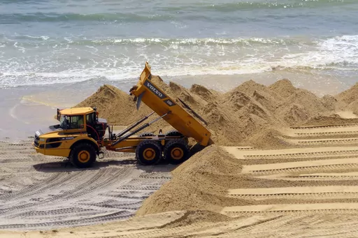 A load of sand is dumped on the beach in front of the Ocean Casino Resort in Atlantic City, N.J., Friday, May 12, 2023. The Ocean, Resorts and Hard Rock casinos want federal officials to expedite a beach replenishment project planned for 2024 so that it creates usable beaches this summer, but the U.S. Army Corps of Engineers says work might not start until the fall. (AP Photo/Wayne Parry, File)