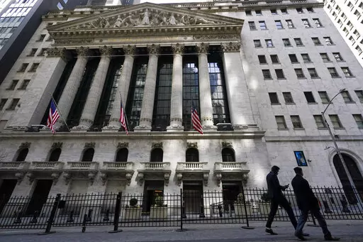 Pedestrians walk past the New York Stock Exchange in New York's Financial District, on March 23, 2021.  Stocks are off to a mixed start on Wall Street Friday, Jan. 7, 2022 as weakness in technology stocks again weighs on the broader market.  (AP Photo/Mary Altaffer, File)