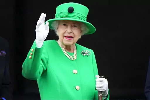Britain's Queen Elizabeth II waves to the crowd during the Platinum Jubilee Pageant at the Buckingham Palace in London, June 5, 2022, on the last of four days of celebrations to mark the Platinum Jubilee. Queen Elizabeth II's death in September 2022 was arguably the most high-profile death this year. In her 70 years on the British throne, she helped modernize the monarchy across decades of enormous social change, royal marriages and births, and family scandals. For most Britons, she was the only