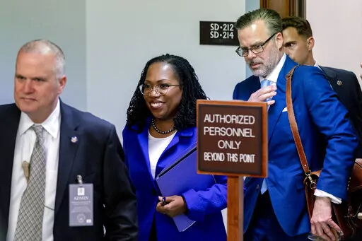 Supreme Court nominee Ketanji Brown Jackson, center, accompanied by her husband Dr. Patrick Jackson, right, steps out during a break in her Senate Judiciary Committee confirmation hearing on Capitol Hill in Washington, Monday, March 21, 2022. The 51-year-old federal judge would be the first Black woman on the Supreme Court. (AP Photo/Andrew Harnik)