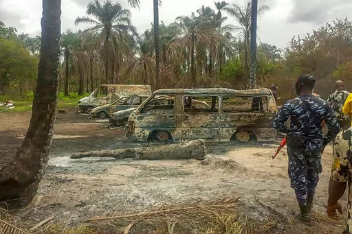 People gather Saturday April 23, 2022 at the site of an explosion that took place the day before at an illegal oil refinery in Ohaji-Egbema local government area in Imo state, southeast Nigeria. At least 100 people are feared to have died in the explosion, authorities told The Associated Press, as the search for bodies at the site and for two people suspected of being involved in the incident intensified. (AP Photo)