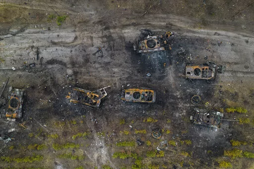 Destroyed Russian armored vehicles sit on the outskirts of Kyiv, Ukraine, March 31, 2022. In the year since Russia invaded Ukraine, disinformation and propaganda have emerged as key weapons in the Kremlin's arsenal. (AP Photo/Rodrigo Abd, File)