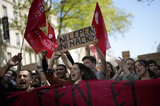 A demonstrator holds a banner that reads: 'Neither Macron nor Le Pen', during a protest in Paris, April 16, 2022. Disgruntled left-wing voters whose candidates were knocked out in the first round of France's election are the wild cards in the winner-takes-all runoff on Sunday April 24, 2022. How they vote — or don’t vote — will in large part determine whether incumbent Emmanuel Macron gets a second five-year term or cedes the presidential Elysee Palace to far-right nationalist Marine Le Pe