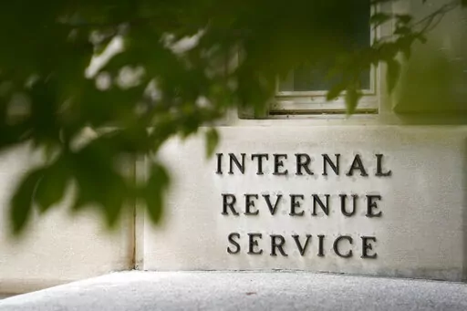 A sign is displayed outside the Internal Revenue Service building May 4, 2021, in Washington.  On Friday, Aug. 19, 2022, The Associated Press reported on stories circulating online incorrectly claiming an online job ad shows that all new employees that the IRS intends to hire after a funding boost in the Inflation Reduction Act will be required to carry a firearm and use deadly force if necessary.  (AP Photo/Patrick Semansky, File)