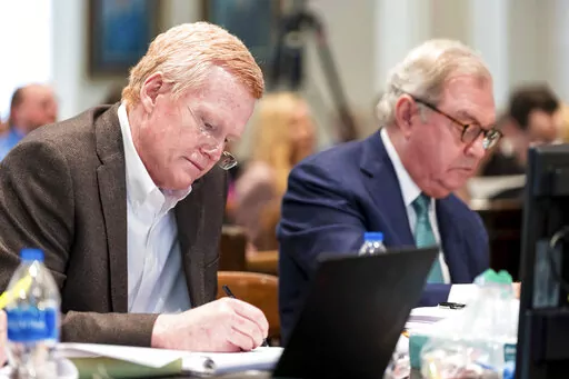 Alex Murdaugh, left, jots down notes during his double murder trial at the Colleton County Courthouse in Walterboro, S.C., on Monday, Feb. 6, 2023. (Jeff Blake/The State via AP, Pool)
