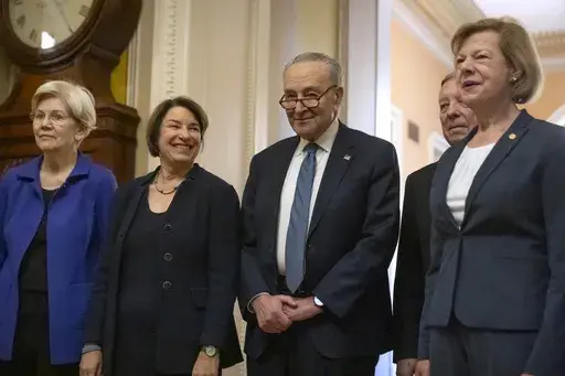 Senators, from left, Sen. Elizabeth Warren, D-Mass., Sen. Amy Klobuchar, D-Minn., Senate Majority Leader Chuck Schumer of N.Y., Sen. Dick Durbin, D-Ill., and Sen. Tammy Baldwin, D-Wis., gather after Senate Democratic leadership elections for the next session of Congress on Capitol Hill, Tuesday, Dec. 3, 2024, in Washington. (AP Photo/Mark Schiefelbein)