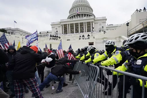 Rioters supporting President Donald Trump try to break through a police barrier at the Capitol in Washington, on Jan. 6, 2021.(AP Photo/Julio Cortez, File)