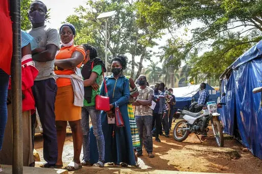 Ugandans queue to receive Pfizer coronavirus vaccinations at the Kiswa Health Centre III in the Bugolobi neighborhood of Kampala, Uganda Tuesday, Feb. 8, 2022.  In the latest Senate package targeted at stopping the coronavirus, U.S. lawmakers dropped nearly all funding for curbing the virus beyond its borders, in a move many health experts describe as dangerously short-sighted. They warn the suspension of COVID aid for poorer countries could ultimately spur the kind of unchecked transmission nee
